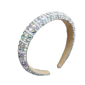 Baroque padded headband with iridescent rhinestones and white pearls on white background