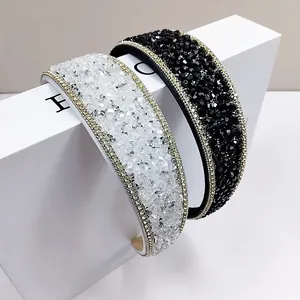 Detailed close-up of sparkling crystal headbands with gold chain edges and rhinestones