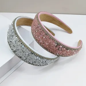 Detail view of pink and silver crystal headbands with gold metallic chain edges