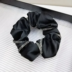 Elegant black satin hair scrunchie with sparkling silver rhinestone trim for women