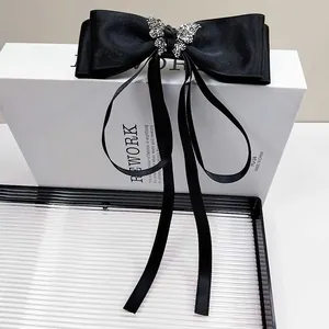 Elegant large black satin bow hair clip with silver rhinestone butterfly and long ribbons