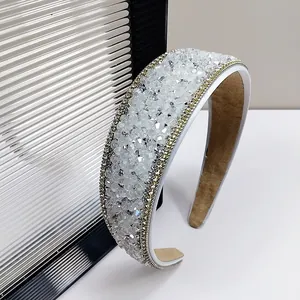 Macro view of crystal headband showing shimmering rhinestones and soft suede inner lining
