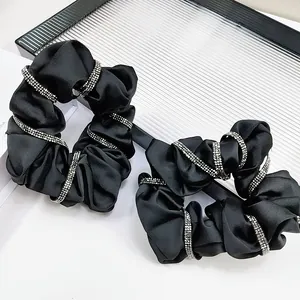 Elegant black silk scrunchies set with sparkling rhinestone bands for high-end hair styling
