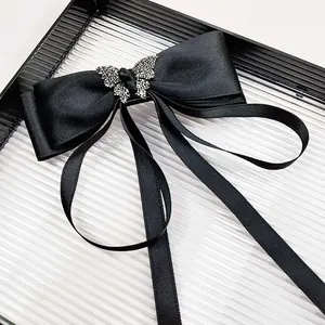 Elegant black satin bow hair clip with silver rhinestone butterfly and long streamers