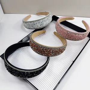 Detailed view of four colorful crystal headbands on a decorative tray for women