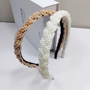 Luxurious wide braided headband with faux pearls in champagne gold and cream white colors