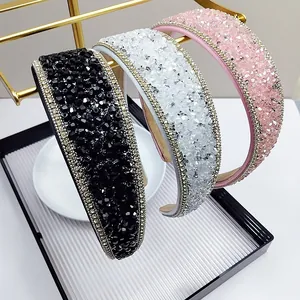 Detail of padded crystal headbands with shiny rhinestones and gold chain trim in three colors