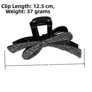 Vue détaillée d'une pince à cheveux de 12,5 cm avec nœud noir et strass scintillants