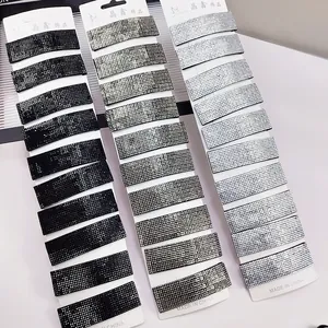 Detail of sparkling rhinestone rectangular hair clips in black, grey and silver colors