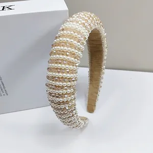 Detail of padded headband with champagne glass beads and white pearls in macro view
