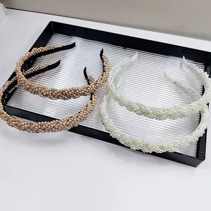 Luxurious wide braided headband set with pearl embellishments in champagne and white