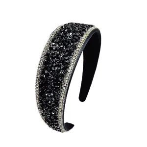Elegant wide headband with black multifaceted crystals and sparkling rhinestones on white