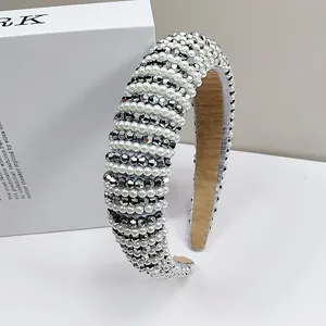 Detailed view of luxury padded headband featuring hand-woven pearls and gray crystals