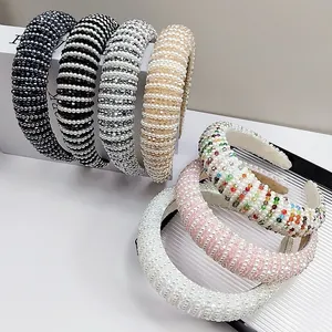 Close-up of padded headbands featuring pearls and colorful crystal beadwork details
