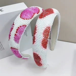 Detail of hand-beaded padded headband with red and pink fruit patterns and white pearls
