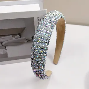 Detailed macro shot of a wide headband with colorful rhinestones and velvet lining