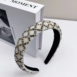 Macro shot of padded headband featuring white pearls and golden rhinestone lattice patterns