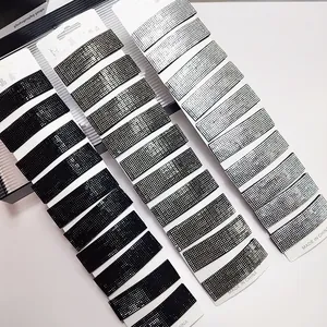 Macro detail of rectangular hair clips with sparkling rhinestones in black, grey, and silver
