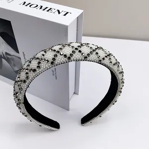 Detail of thickened headband featuring dense white pearls and gray diamond geometric pattern