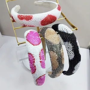 Close-up of four thick beaded headbands with colorful polka dot patterns on display
