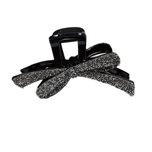 Pince à cheveux noire élégante avec nœud scintillant et strass brillants de luxe
