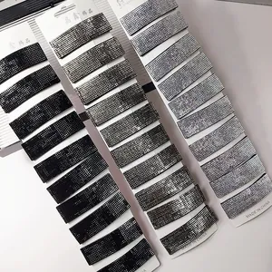 Macro detail of rectangle hair clips set with shimmering rhinestones in black and silver