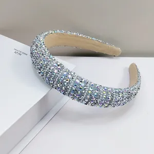 Macro detail of padded headband with colorful rhinestones on a white display stand