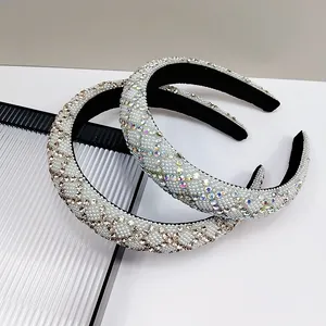 Detail of wide padded headbands featuring champagne rhinestones and white faux pearls