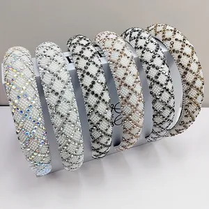 Detail view of rhinestone and pearl padded headbands in various colors on white stands