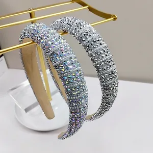 Detailed view of padded headbands featuring rhinestones and a soft beige lining