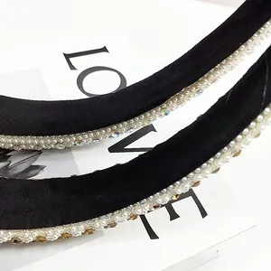 Detailed close-up of a velvet headband featuring exquisite hand-sewn pearls and rhinestones