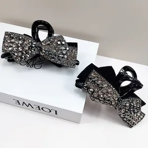 Elegant black bow hair claw set with sparkling rhinestones in a Korean fashion style