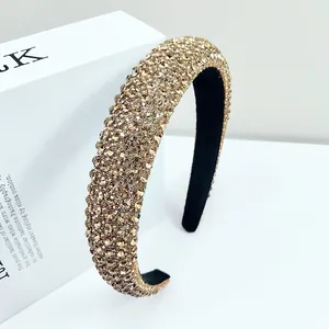 Detailed close-up of champagne gold rhinestones on a thick padded fashion headband