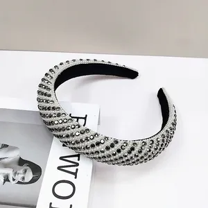 Detail of padded headband with white pearls and dark grey rhinestones in diagonal pattern