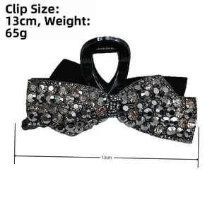 Detailed view of 13cm black bow hair claw clip with silver rhinestones and weight info