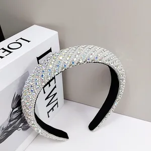 Detail view of crystal rhinestone and white pearl headband with black velvet lining