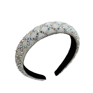 Luxury padded headband with sparkling colorful rhinestones and white pearls on a white base