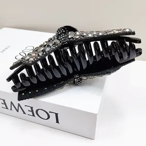 Sparkling large bow hair claw clip with silver crystals and elegant black finish