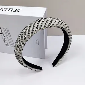 Close-up of luxury padded headband with sparkling black rhinestones and white pearls