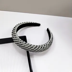 Close-up of wide headband featuring premium black and white striped crystal embellishments