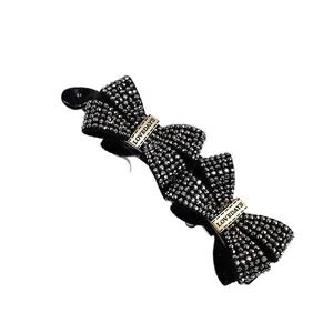 Elegant black banana hair clip with sparkling rhinestones and Lovedays metal detail