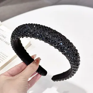 Detail of a luxury black padded headband featuring dense charcoal grey rhinestones