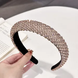 Close-up of luxury wide headband with shimmering champagne gold rhinestones