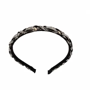 Close-up of sparkling rhinestone braided headband showing 1.3cm width and 42g weight details