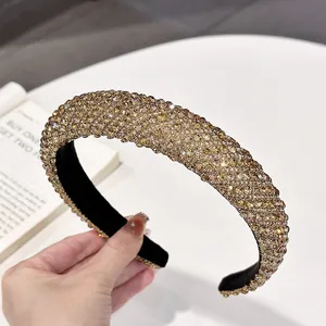 Detail of a padded champagne rhinestone headband with vintage velvet luxury finish