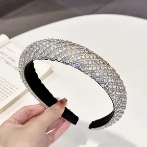 Close-up of thick headband with multi-color AB rhinestones and black fabric lining