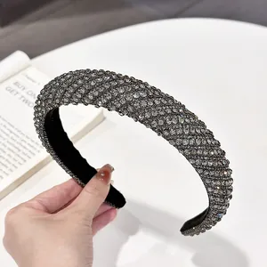 Detail of wide headband with smoky grey rhinestones and thick retro padded design