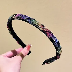 Close-up of handmade braided headband with colorful rhinestones and soft black lining