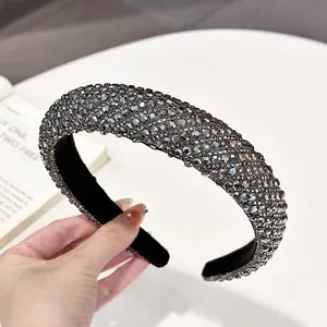 Macro detail of high-quality wide headband with dense grey rhinestones on black base