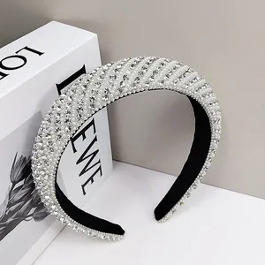 Padded headband with elegant pearls and sparkling rhinestones for a high-cranial top look
